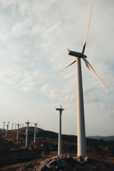 modern wind farm line a rolling hillside