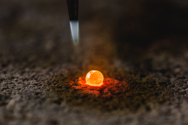 molten metal drop on bed of ash