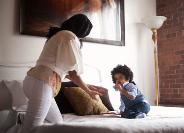 mom and toddler on bed