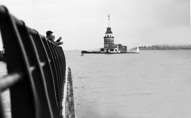 monochrome image of people looking out at the water