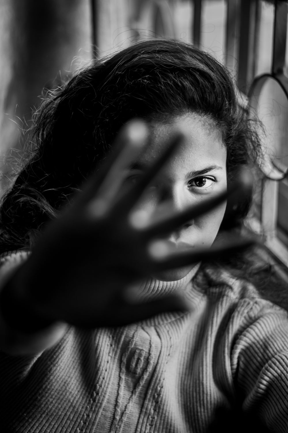 monochrome portrait of woman holding her hand out