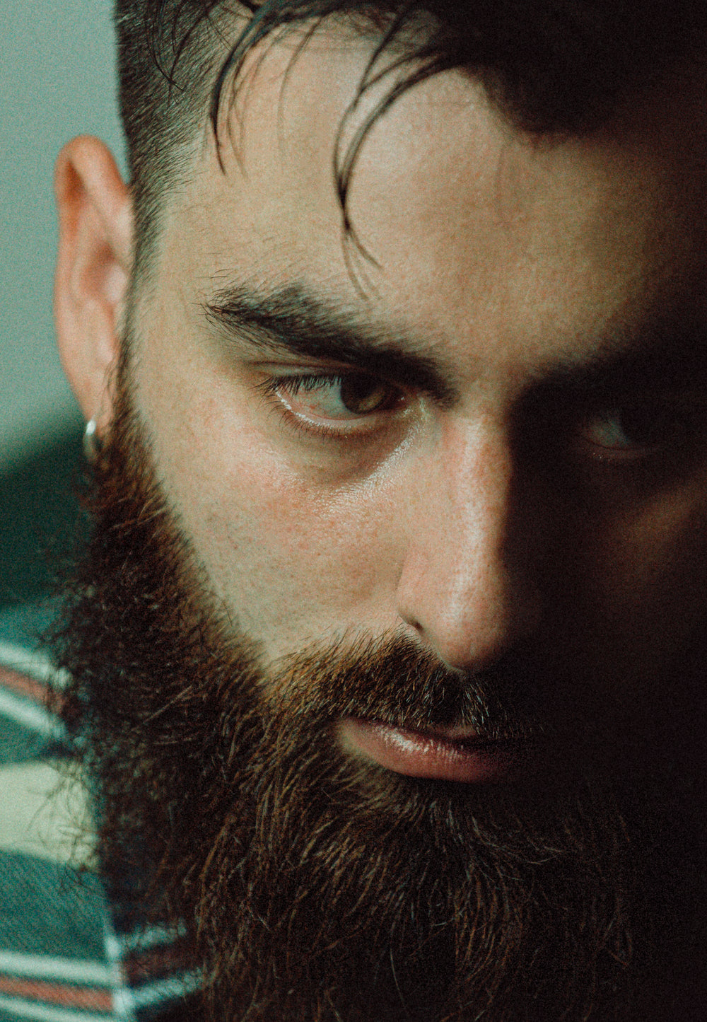 moody close up of mans face looking down