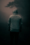 moody image of a person in grey hooded sweater
