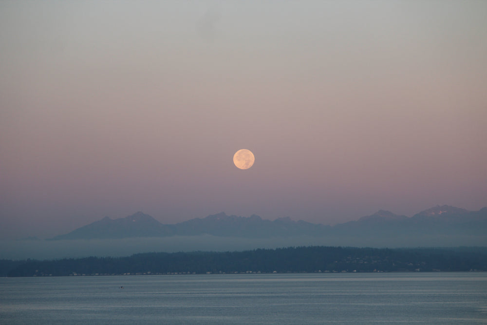 moonrise over lake and mountains