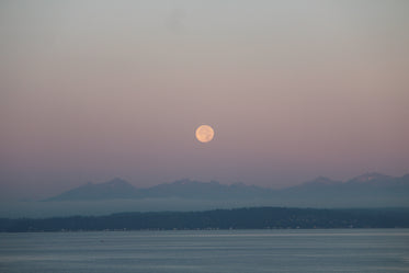 moonrise over lake and mountains