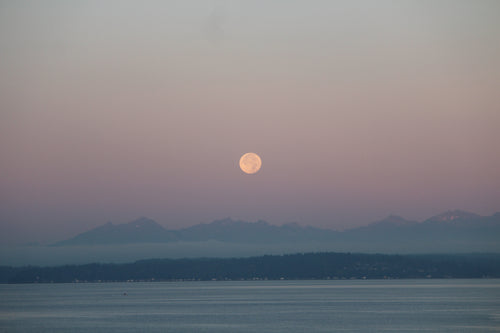 moonrise over lake and mountains