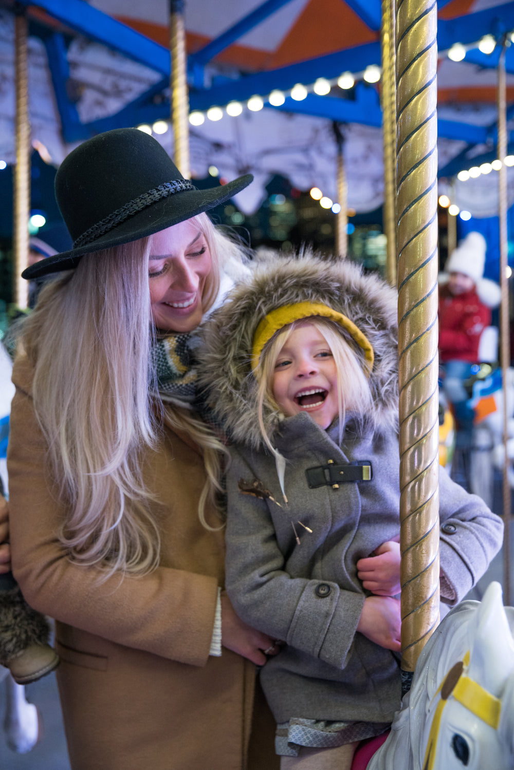 mother and daughter on carousel