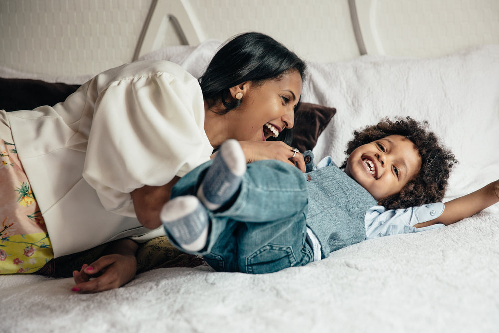 mother tickling her son