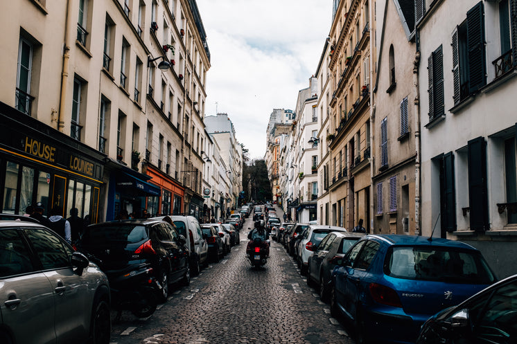 motorcycle-rides-up-narrow-cobblestone-s