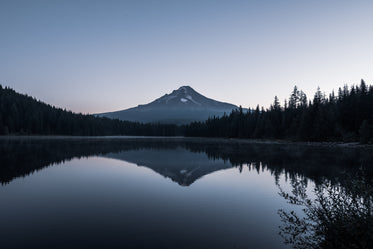 mountain by glassy lake with reflection