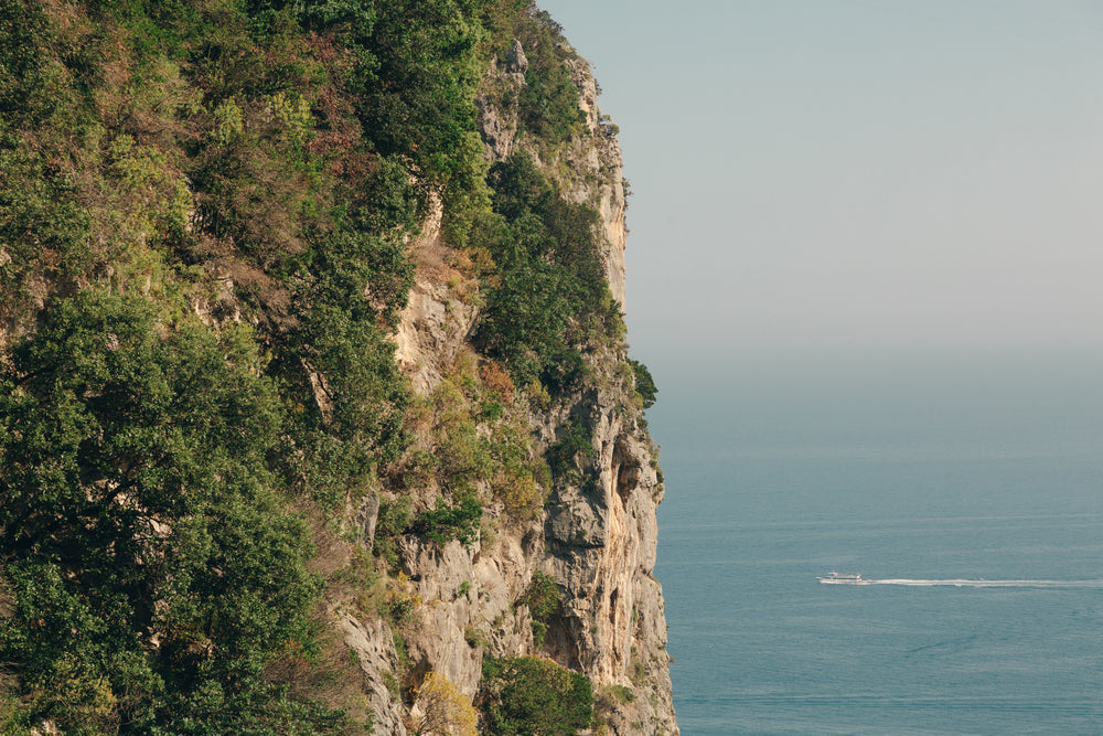 mountain side water and boat