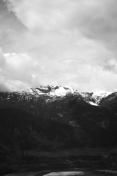 mountain tops under a cloudy sky in monochrome