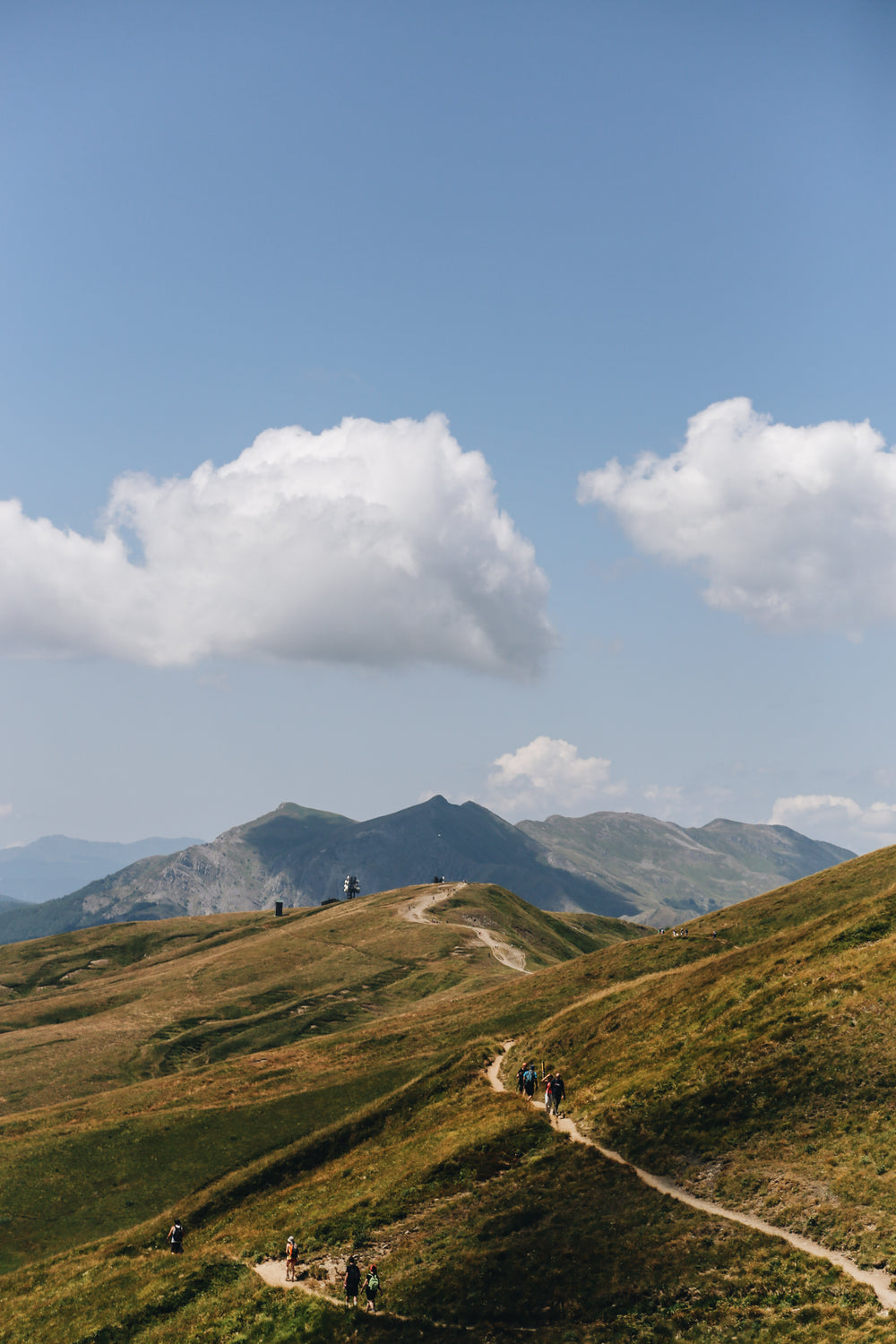 mountains and hikers on a pathway