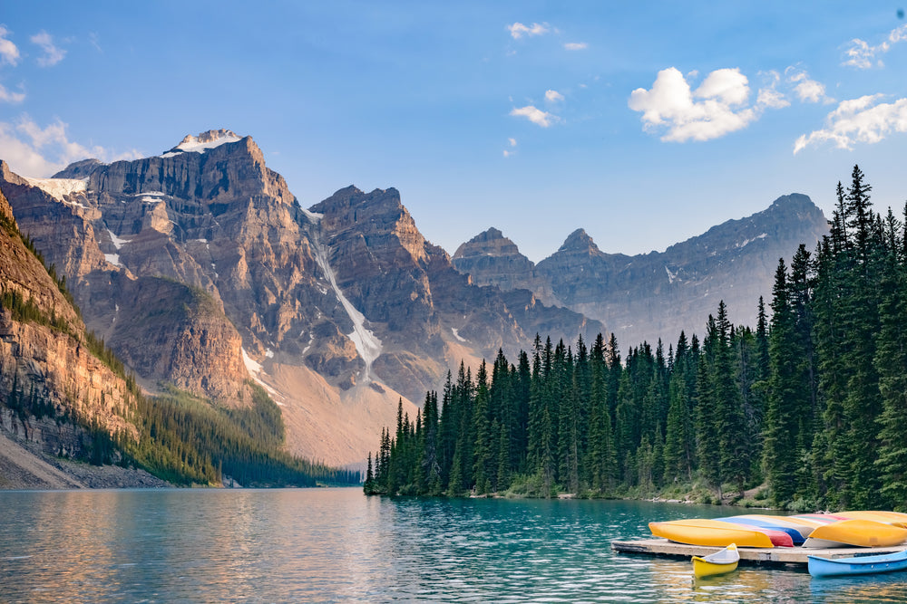 mountains capture the sun over lake