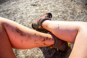 mud-spattered woman hiker's legs