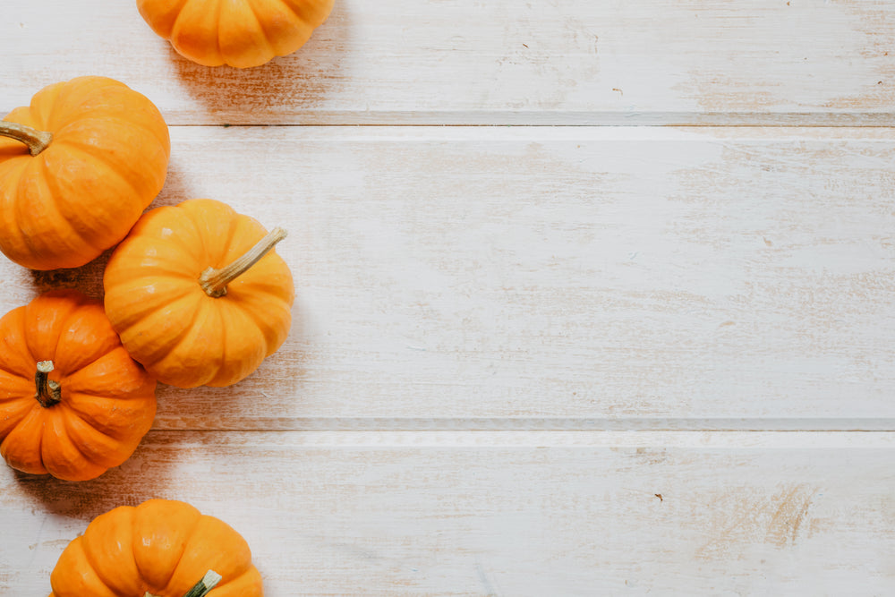 multiple pumpkins on wood