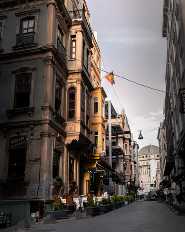 narrow city street with rustic tall buildings