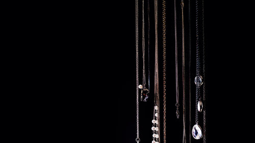 necklaces hanging on black