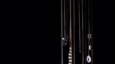 Browse Free HD Images of Necklaces Hanging On Black