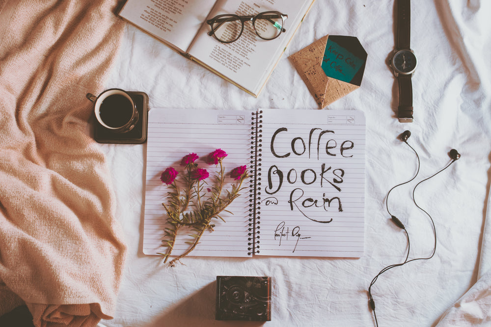 notebook with coffee books and rain