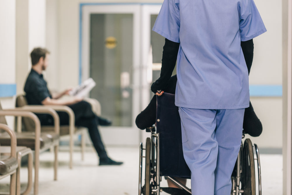 nurse pushing wheelchair