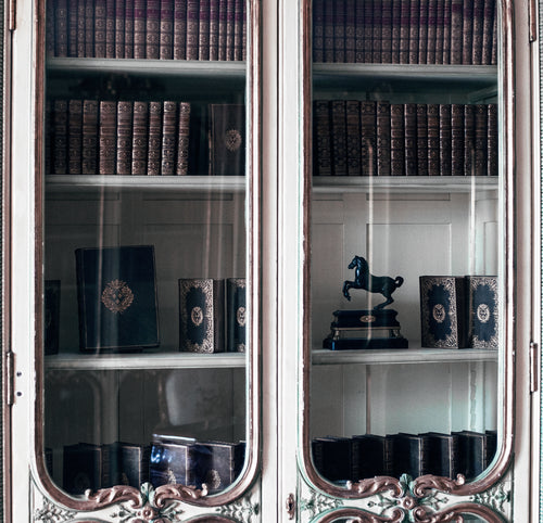 old books in an antique cabinet