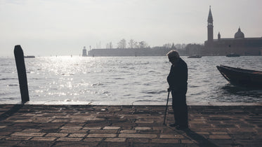 old man thinking by the harbor