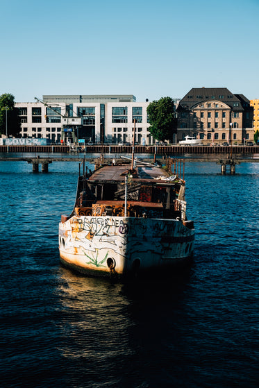 old rustic boat sets sail on blue water