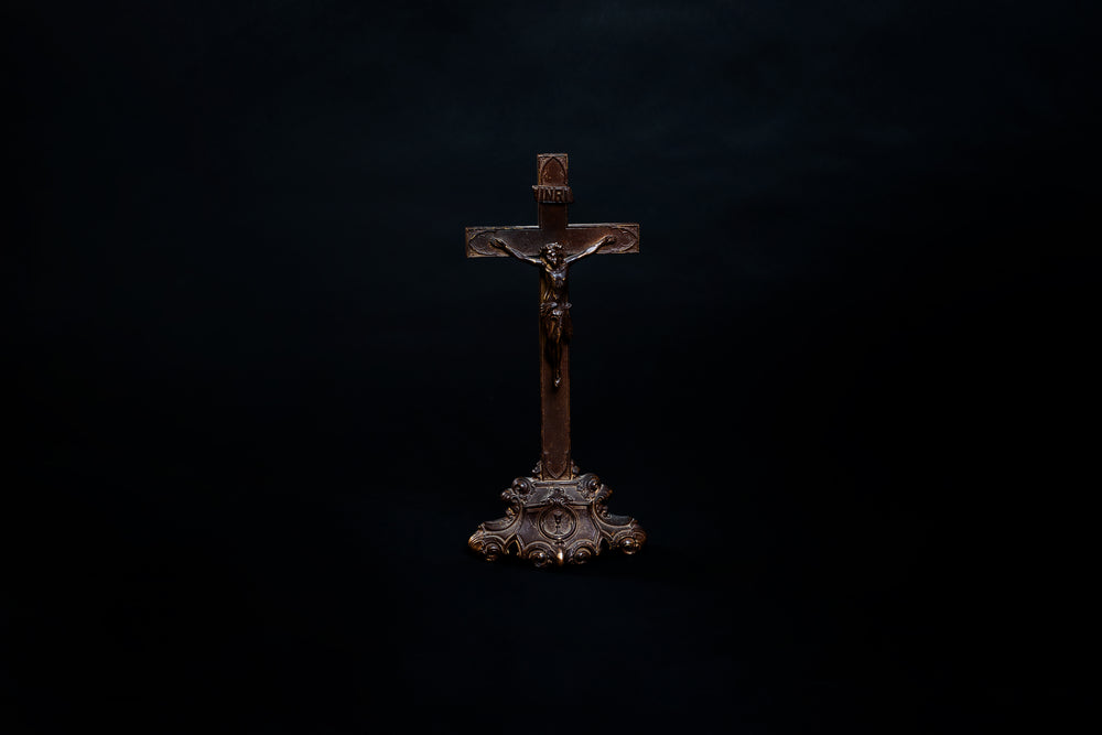 old wooden cross on black background