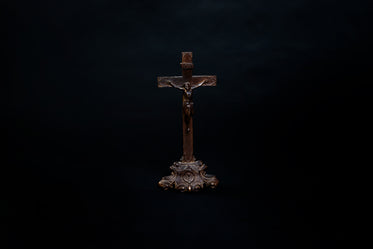 old wooden cross on black background