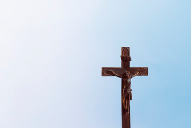 old wooden cross on blue background