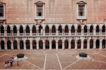 open stone courtyard with white archways