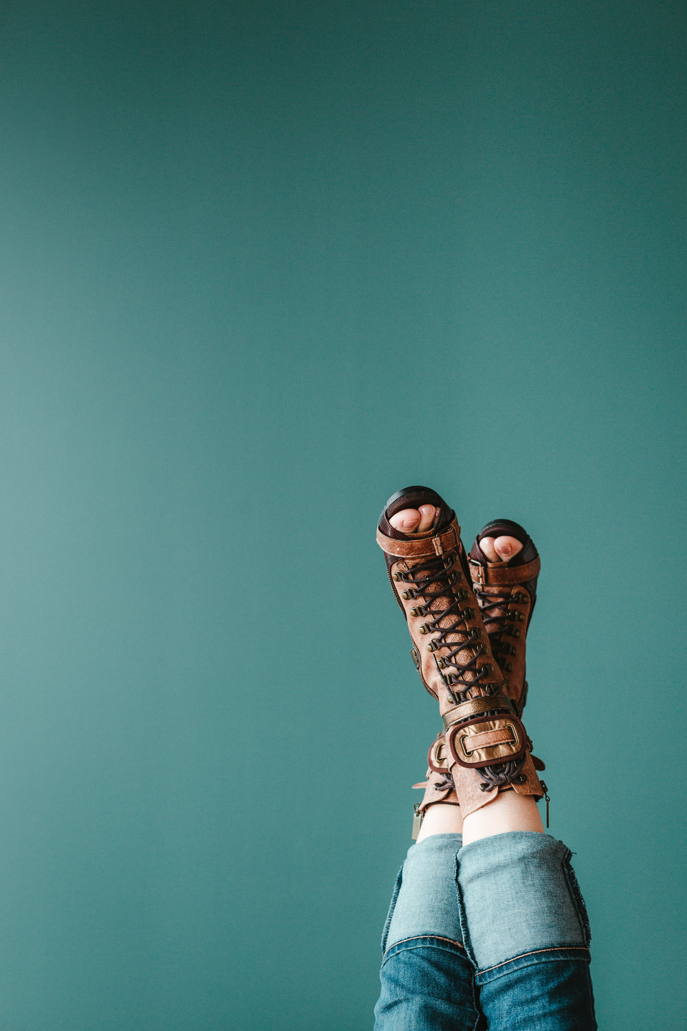 open toe boots against a blue background