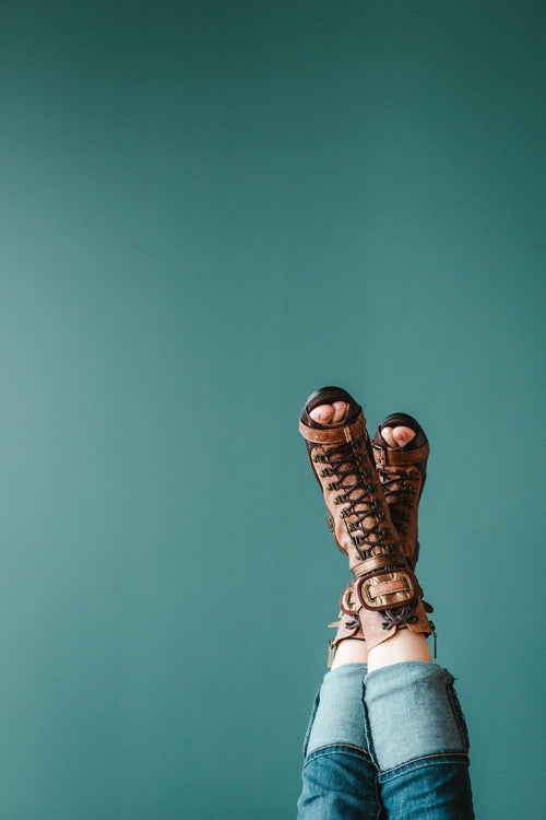 open toe boots against a blue background