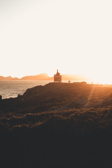 orange light rays over boastline at sunset