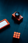 orange rubiks cube camera and hard drive