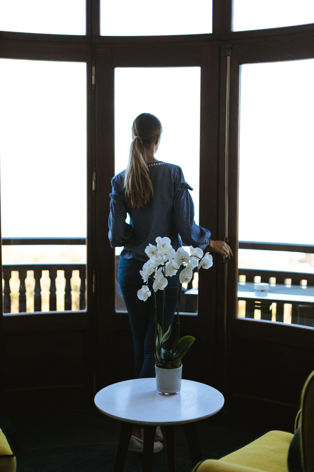 orchid decor and woman enjoying view