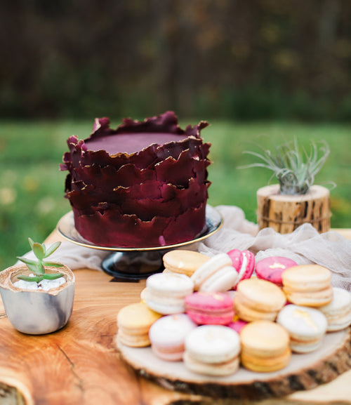 outdoor dessert table with macarons and cake