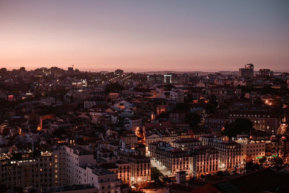 overhead view of city skyline with pink sunset behind