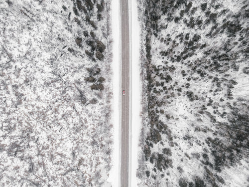 overhead view of red pickup truck on a forest road