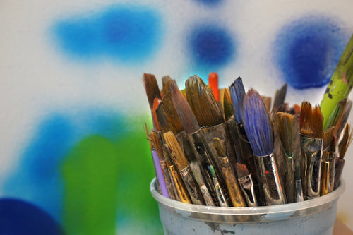 paint brushes in bucket
