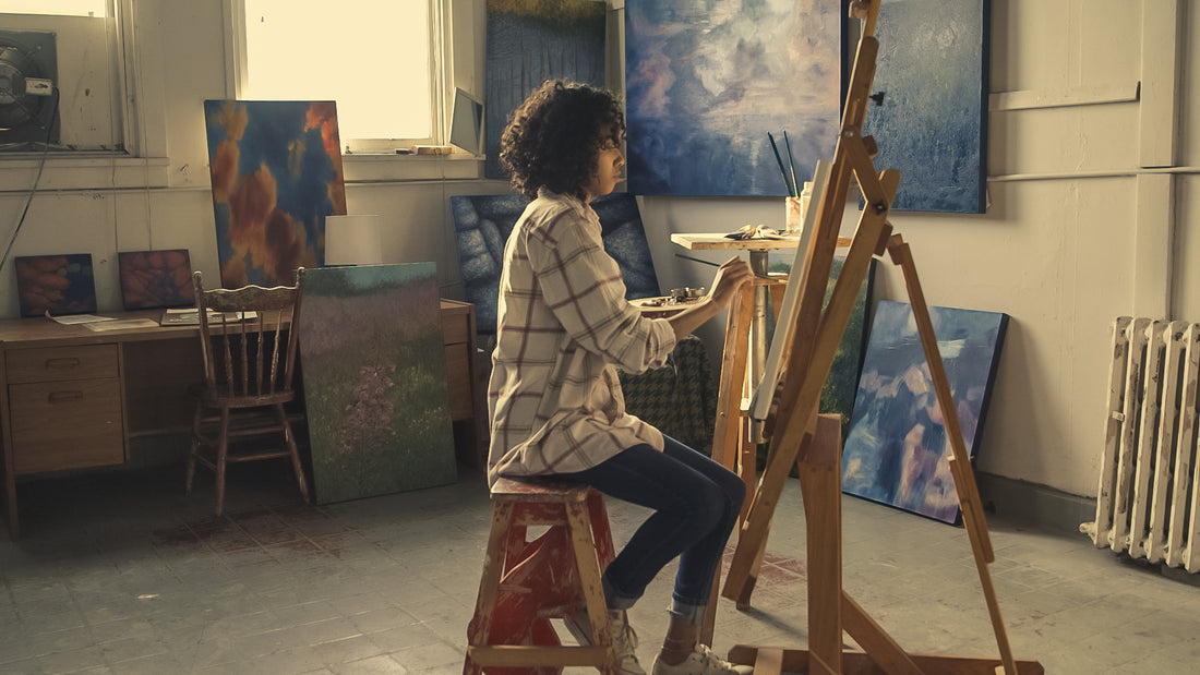 A painter mid brushstroke in a working studio