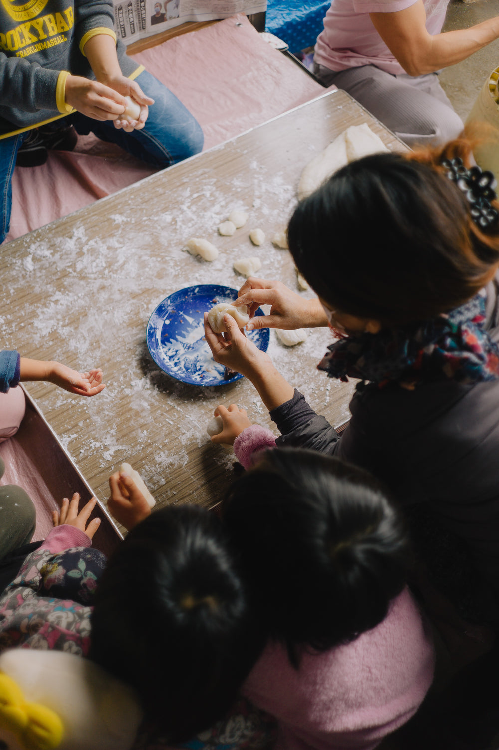 pair of busy hands molding white dough