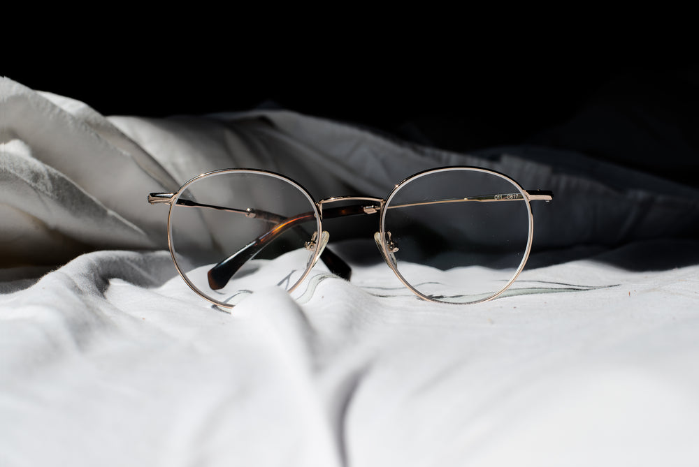 pair of glasses on a bed