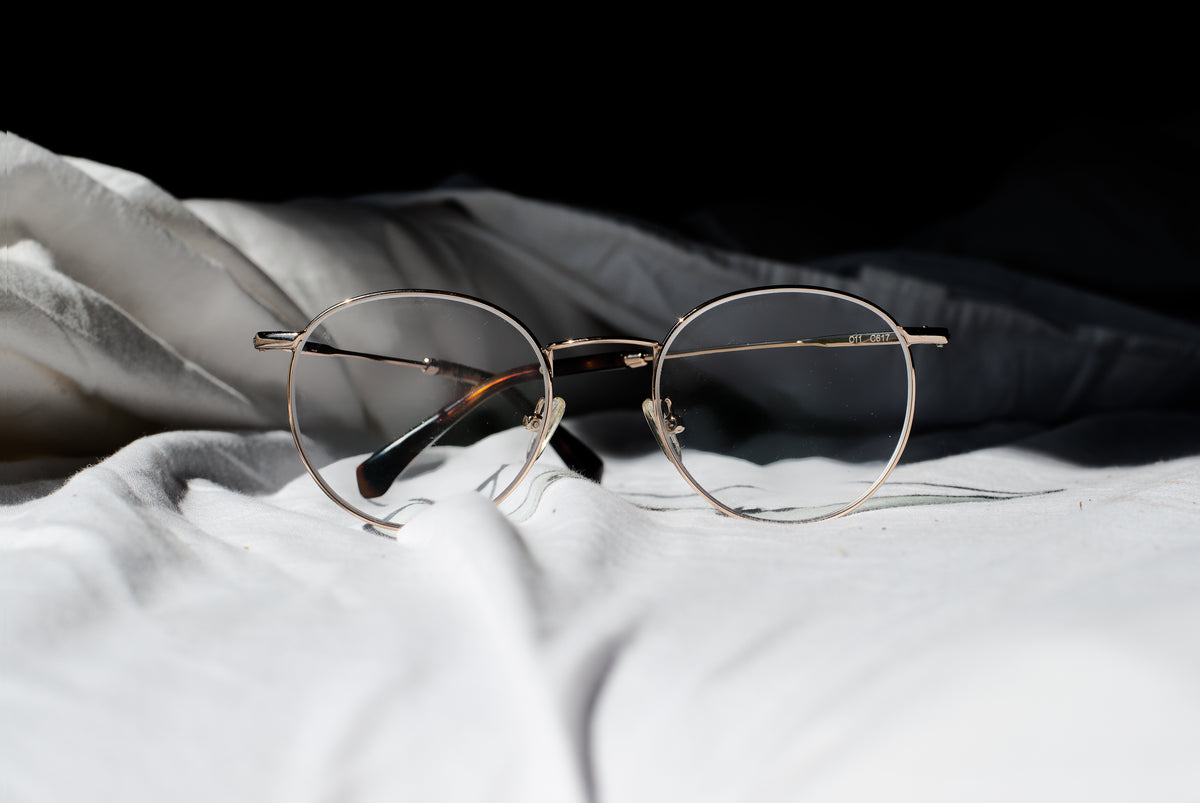 pair of glasses on a bed