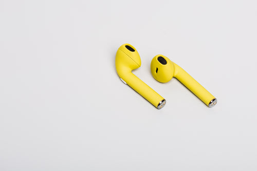pair of yellow earbuds