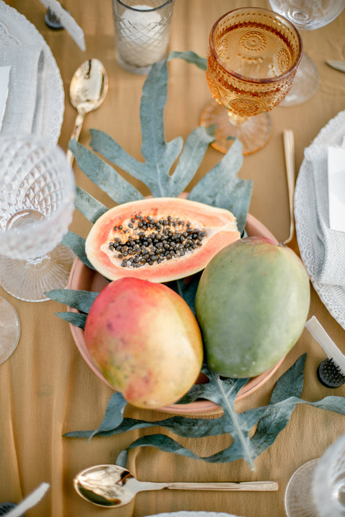 papaya fruit at centre of table setting