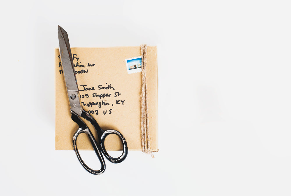 parcel and packing scissors on a white background