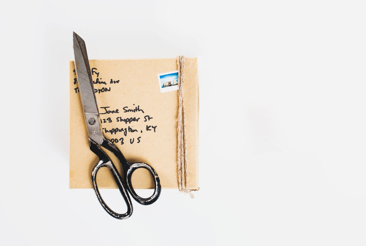 Parcel And Packing Scissors On A White Background