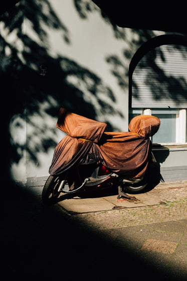 parked bike with a orange covering